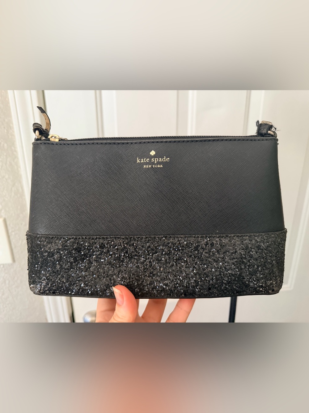 kate spade black glitter wristlet clutch with gold logo plaque